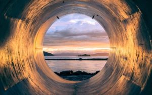 water and sunset view through pipe
