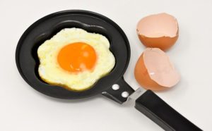 Fried egg in frying pan with egg shells