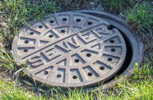 Metal sewer manhole cover